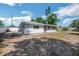 Backyard view of the house showcasing an enclosed porch and privacy fence at 5817 26Th W St, Bradenton, FL 34207