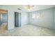 Light-filled bedroom with tiled floors, ceiling fan, and closet for optimal storage at 5817 26Th W St, Bradenton, FL 34207