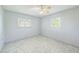 Bright bedroom with new flooring, ceiling fan, and natural light from two windows at 5817 26Th W St, Bradenton, FL 34207