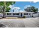 Charming single-story home with a well-maintained lawn, a metal roof and wide driveway at 5817 26Th W St, Bradenton, FL 34207