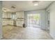 Spacious kitchen with white cabinets and stainless steel appliances and a view to outside at 5817 26Th W St, Bradenton, FL 34207