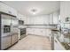 Modern kitchen featuring stainless steel appliances, granite countertops, and white cabinets at 5817 26Th W St, Bradenton, FL 34207