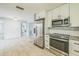 Bright kitchen featuring stainless steel appliances, granite countertops, and white cabinets at 5817 26Th W St, Bradenton, FL 34207