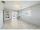Bright living room featuring tile flooring, sliding glass doors, and a light neutral color palette at 5817 26Th W St, Bradenton, FL 34207