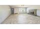 Open-concept living room featuring a stone fireplace, neutral paint, and tile flooring at 5817 26Th W St, Bradenton, FL 34207