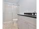 Bathroom featuring a modern vanity, granite countertop, and a sliding glass door shower at 5186 Fleming St, Port Charlotte, FL 33981