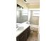 The bathroom has a vanity, toilet, shower, and tile flooring at 2202 Whitney Pl, Valrico, FL 33594