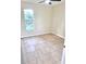 Bedroom featuring tile flooring, a window, and neutral colored walls at 2202 Whitney Pl, Valrico, FL 33594