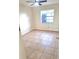 Bedroom with tile flooring, a ceiling fan, and a window providing natural light at 2202 Whitney Pl, Valrico, FL 33594