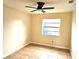 This bedroom has a ceiling fan, window, tile flooring, and neutral-painted walls at 2202 Whitney Pl, Valrico, FL 33594