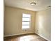 A beige bedroom features tile flooring, a bright window and an overhead light at 2202 Whitney Pl, Valrico, FL 33594