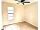 This bedroom features a ceiling fan, window, tile flooring, and neutral-painted walls at 2202 Whitney Pl, Valrico, FL 33594