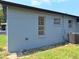 The exterior of the home is painted gray and features a new air conditioning unit at 2202 Whitney Pl, Valrico, FL 33594