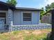 The exterior of the home features stone accents and a new gray paint job at 2202 Whitney Pl, Valrico, FL 33594