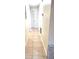 Hallway with tile flooring, neutral walls, closet, and access to various rooms at 2202 Whitney Pl, Valrico, FL 33594