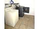 This laundry room has a washer and dryer with tile flooring at 2202 Whitney Pl, Valrico, FL 33594