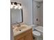 Updated bathroom with a bathtub, shower, new vanity, sink, updated mirror and modern lighting at 3716 Mistwood Dr, Tampa, FL 33619