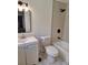 Clean bathroom featuring a toilet, bathtub with shower, and an updated vanity with a large mirror at 3716 Mistwood Dr, Tampa, FL 33619