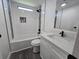 Bright bathroom featuring modern fixtures, a tub with shower, and a stylish white vanity at 3906 Sarah Dr, Wesley Chapel, FL 33543