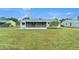 Spacious backyard featuring a covered patio, ideal for outdoor gatherings and relaxation at 5052 Trekell St, North Port, FL 34287