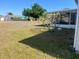 Spacious backyard with mature landscaping, offering plenty of room for outdoor activities at 5052 Trekell St, North Port, FL 34287