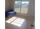 Bedroom with tile floors, natural light from a window, and a bed against the wall at 5052 Trekell St, North Port, FL 34287