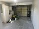 Garage with storage cabinets, overhead door, and ample space for parking and projects at 5052 Trekell St, North Port, FL 34287