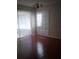 Bedroom with hardwood floors, shutters, and sliding glass doors at 2011 N 61St St, Tampa, FL 33619
