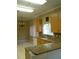 Well-lit kitchen with tile floors, granite countertops, and light wood cabinets at 2011 N 61St St, Tampa, FL 33619