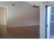 Bright living room with laminate floors, ceiling fan, and sliding glass door at 2011 N 61St St, Tampa, FL 33619