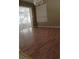 Spacious living area featuring laminate flooring, natural light and sliding door access to exterior at 2011 N 61St St, Tampa, FL 33619