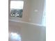 Bright living room with tile floors, a large window, and a door to the outside at 2011 N 61St St, Tampa, FL 33619