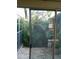 Cozy brick patio view through sliding glass doors overlooking the beautiful tropical plants and landscaping at 2011 N 61St St, Tampa, FL 33619