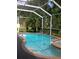 Inviting in-ground pool with a spa and screened enclosure at 2011 N 61St St, Tampa, FL 33619