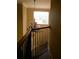 Elegant staircase features decorative chandelier and an upper landing window that provides natural light at 2011 N 61St St, Tampa, FL 33619