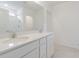 Bright bathroom features a double vanity with modern fixtures and a large mirror at 9661 Summers Cay Cir, Thonotosassa, FL 33592