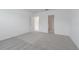 Bright bedroom with neutral walls and gray carpet with open doorway at 9661 Summers Cay Cir, Thonotosassa, FL 33592