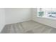 Bright bedroom with neutral walls and gray carpet under a window at 9661 Summers Cay Cir, Thonotosassa, FL 33592
