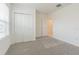Carpeted bedroom with natural light from a window and closet with sliding doors at 9661 Summers Cay Cir, Thonotosassa, FL 33592