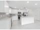 A bright and modern kitchen with white cabinets, stainless steel appliances, and a large center island at 9661 Summers Cay Cir, Thonotosassa, FL 33592