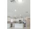 Bright kitchen features white cabinets, stainless appliances, and an island with ample counter space at 9661 Summers Cay Cir, Thonotosassa, FL 33592