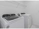 Laundry room with a Whirlpool washer and dryer and a metal shelf at 9661 Summers Cay Cir, Thonotosassa, FL 33592