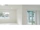 A bright living room with neutral walls and tile flooring and glass sliding door at 9661 Summers Cay Cir, Thonotosassa, FL 33592
