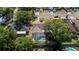 An aerial view shows a screened pool and mature trees surrounding the home at 414 Mahogany Dr, Seffner, FL 33584