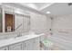 Well-lit bathroom with a white vanity, toilet, and a bathtub with shower combination at 414 Mahogany Dr, Seffner, FL 33584