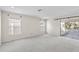 Large bonus room with lots of natural light from three windows and a glass sliding door at 414 Mahogany Dr, Seffner, FL 33584