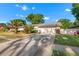 The exterior of the home shows a two-car garage and palm trees in the front yard at 414 Mahogany Dr, Seffner, FL 33584