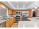 Well-equipped kitchen with stainless steel appliances, ample counter space, and classic wood cabinetry at 414 Mahogany Dr, Seffner, FL 33584