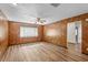 Cozy living room with wood-look flooring, paneled walls and bright natural light at 414 Mahogany Dr, Seffner, FL 33584