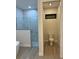 Full bathroom features walk-in shower with marble-look tile and enclosed toilet at 20296 Rutherford Ave, Port Charlotte, FL 33952